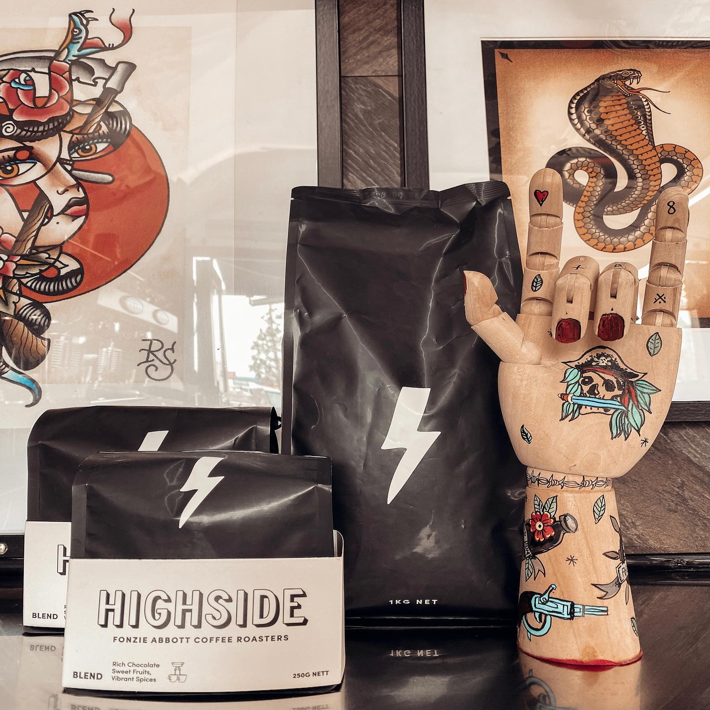 Fonzie Abbott coffee beans in 1kg and 500mg bags surrounded by decorations.